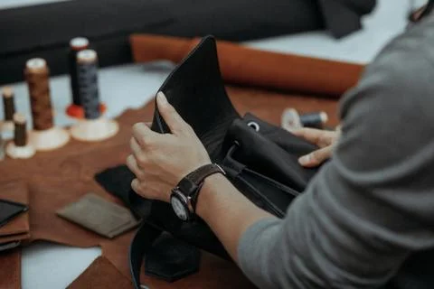 The master makes a leather bag. A close up, a product from skin in hands. Stockfoto's