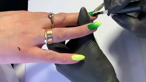 Master makes a manicure client. Hands - close-up. Stock Footage 107534143