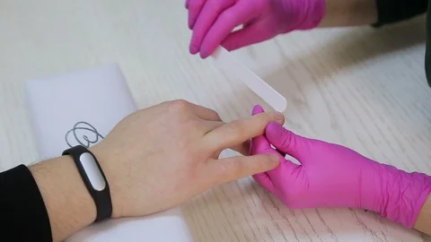Master makes manicure for the man in salon Stock Footage 106405633