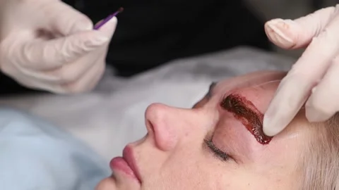 The master makes permanent eyebrow makeup with special pigment Stock Footage 164643048