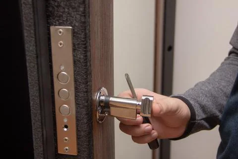 Master makes repairs changes lock in doors Stock Photos