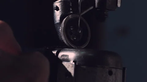 The master makes shoes in the workshop. Side view of using sewing machine to Stock Footage 95929742