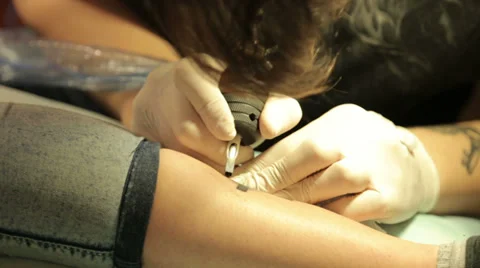 Master Makes Tattoo On Leg Stock Footage 38385667