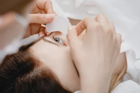 Master making fake set lash Eyelash extension procedure, work with patch for eye Stock Photos