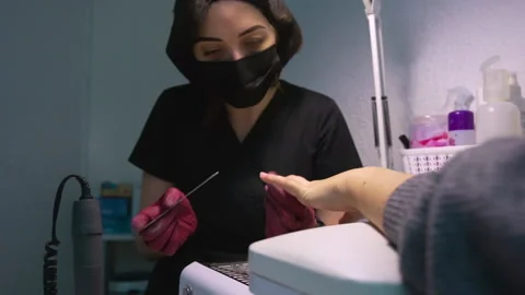 The master of manicure carefully makes a neat shape of the client's nails Stock Footage 146489035