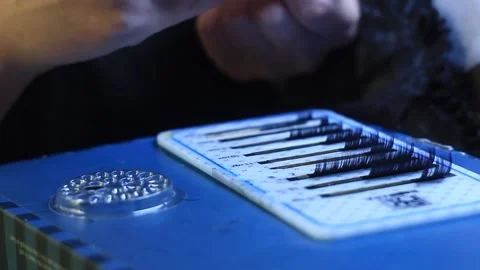 Master with manicure is choosing false lashes in a set with tweezers, close-up Stock Footage 150401719