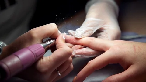 Master of manicure makes hardware manicure, woman comes to the manicure salon Video stock 71575774