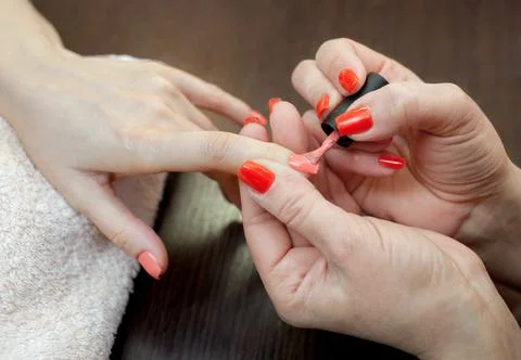 Master of manicure makes nail extensions gel in the beauty salon. Stock Photos