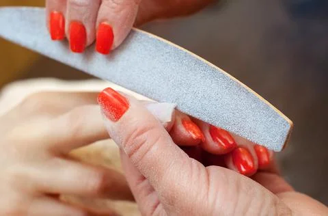 Master of manicure makes nail extensions gel in the beauty salon. Stock Photos