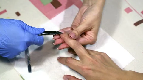 Master of manicure prepares nails for applying varnish Stock Footage 90410818