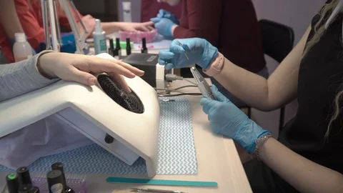 Master of manicure prepares to remove varnish from nails Stock Footage 87466749