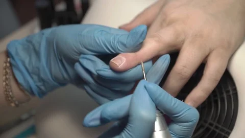 Master of manicure removes cuticles on nails in beauty salon Stock Footage 87469546