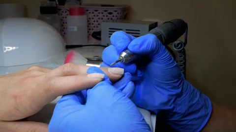 Master of manicure removes cuticles on nails.slow motion. close up Stock Footage 114314570