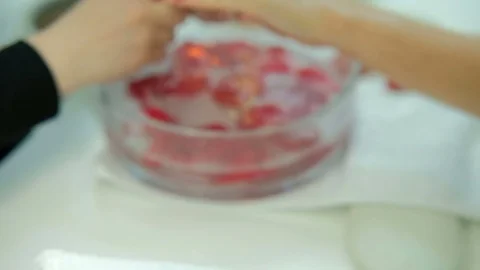 Master of manicure washes scrub off hands of client in cup with water. Stock Footage 78122292