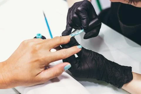 Master of manicure in work progress. Beauty salon. Hand treatment concept. Stock Photos