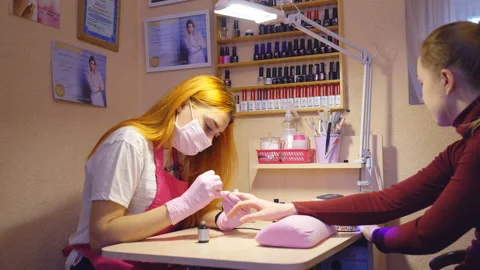 Master of manicure at work. Services in the beauty salon. Two young attractive Stock Footage 87125661