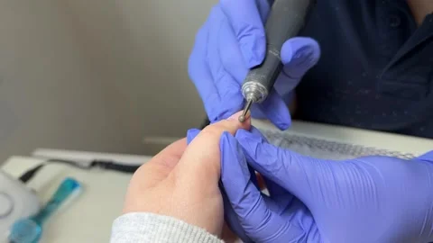 Master manicurist doing manicure procedure for woman client in beauty salon Stock Footage 317850179