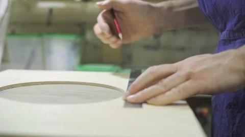 Master is measuring with metal ruler and drawing with pencil Stock Footage 102858557