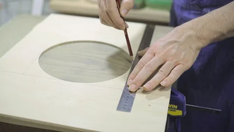 Master is measuring with metal ruler and drawing with pencil Stock Footage 102858647