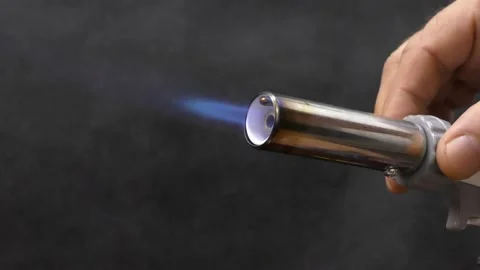 A master mechanic adjusts the flame of a gas burner. Stock Footage 155688193