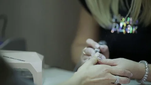 Master milling machine removes the varnish in the beauty salon Stock Footage 73764433