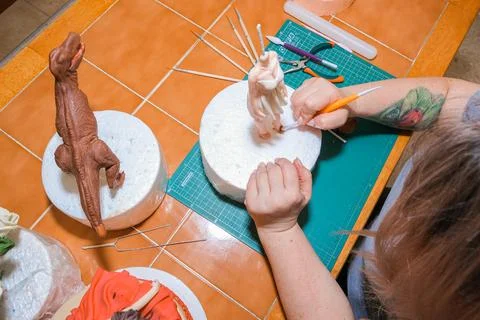 Master in the modeling of figures from confectionery mastic Stock Photos