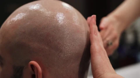 The master moisturizes the head with gel Stock Footage 157621231