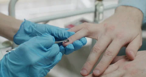 The master of the nail service gives shape to the nails with a nail file. Stock Footage 236454870