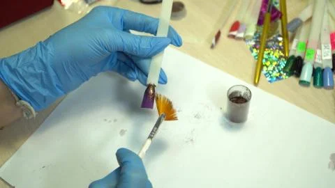 Master of nails cleans the tips on a stick Stock Photos