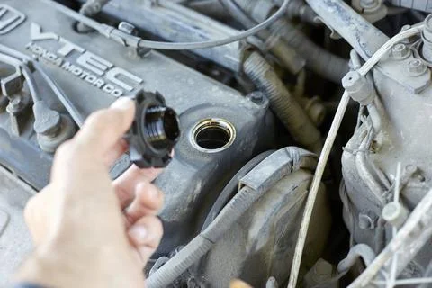 The master opened the neck in the engine to change the oil Stock Photos