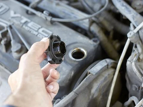 The master opened the neck in the engine to change the oil Stock Photos