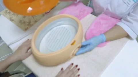 The master opens the lid of the container in which the melted paraffin Stock Footage 81097043