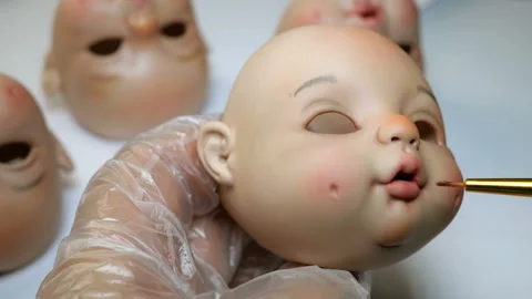 Master painter carefully paints lips of blank for doll. Stock Footage 116610926