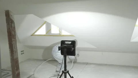 Master painter paints and primes a wall with an airless paint sprayer Stock Footage 317394861