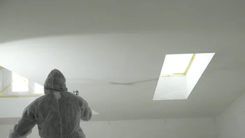 A master painter  paints and primes a wall with an airless paint sprayer Video stock 317394966