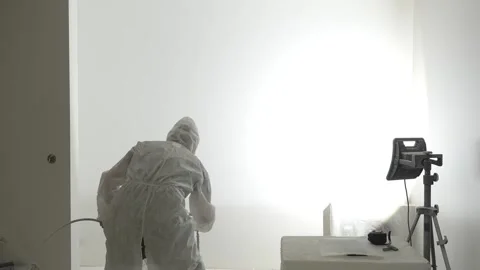 A master painter  paints and primes a wall with an airless paint sprayer Video stock 317395030