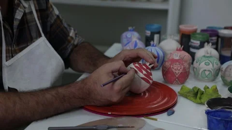 A master paints a sugar bowl in the shape of a pomegranate Stock Footage 313403670