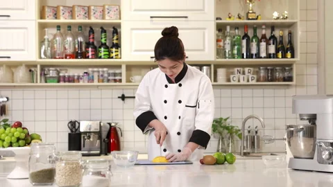 Master pastry chef baker hands in gloves slicing dicing a fresh ripe mango on Stock Footage 339206895