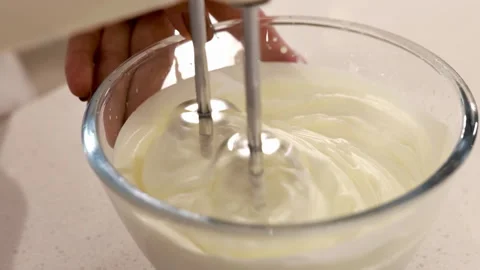 Master pastry chef hand adds sugar and flour whipping raw egg whites with Stock Footage 339380225