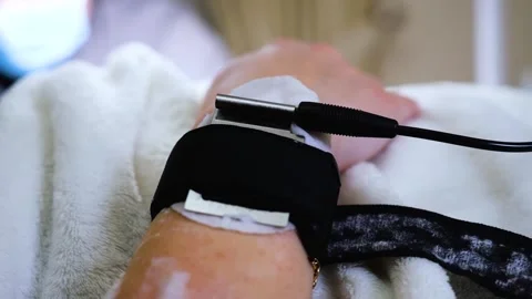 A master performs an electrodepilation procedure on a girl's arm Stock Footage 270173665
