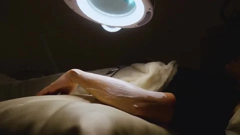 A master performs an electrodepilation procedure on a girl's arm Stock Footage 270173746
