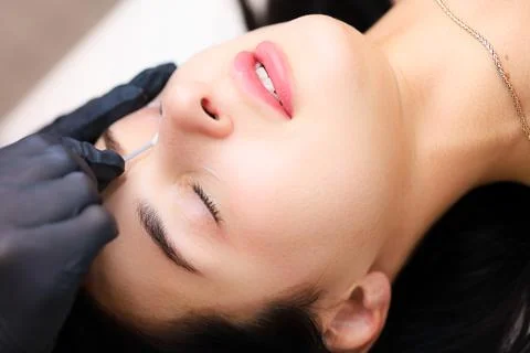 The master performs lamination of cilia Stock Photos