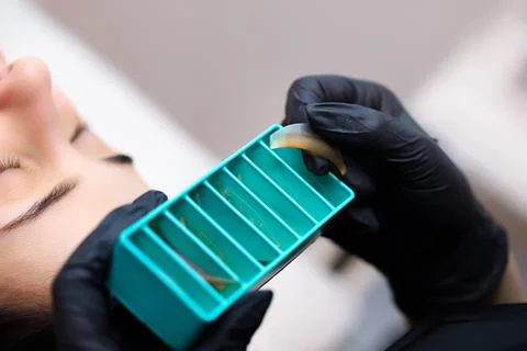 The master performs lamination of cilia Stock Photos