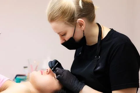 The master performs lamination of cilia Stock Photos