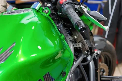 The master performs maintenance on the motorcycle. Stock Photos