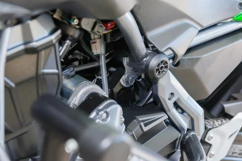 The master performs maintenance on the motorcycle. Stock Photos