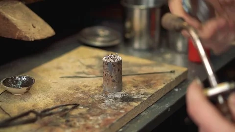 Master performs melting silver soldering iron in a special form. Stock Footage 72963686
