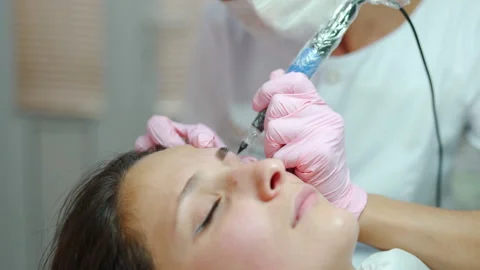 Master performs microblading permanent tattoo for eyebrows. Video stock 294981323