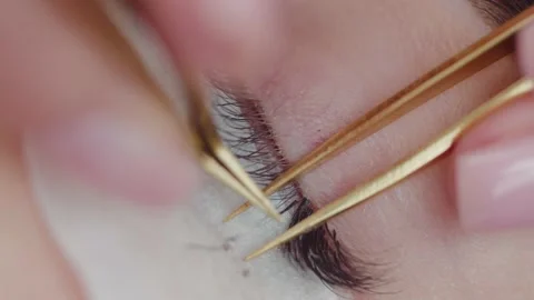 The master performs the procedure of eyelash extensions Stock Footage 173641437