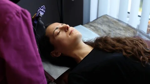 Master permanent makeup eyebrows makes the patient brow Stock Footage 122700015